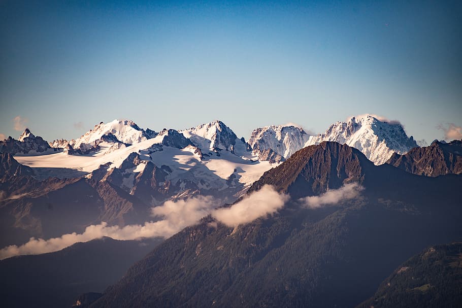 landscape photography of black and white mountains under blue sky at daytime HD wallpaper