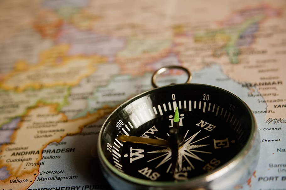 closeup photo of silver-colored compass, navigation, map, direction