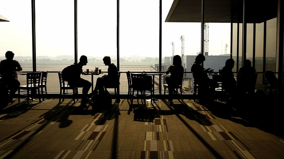 silhouette of people sitting on chair beside glass wall, wait HD wallpaper
