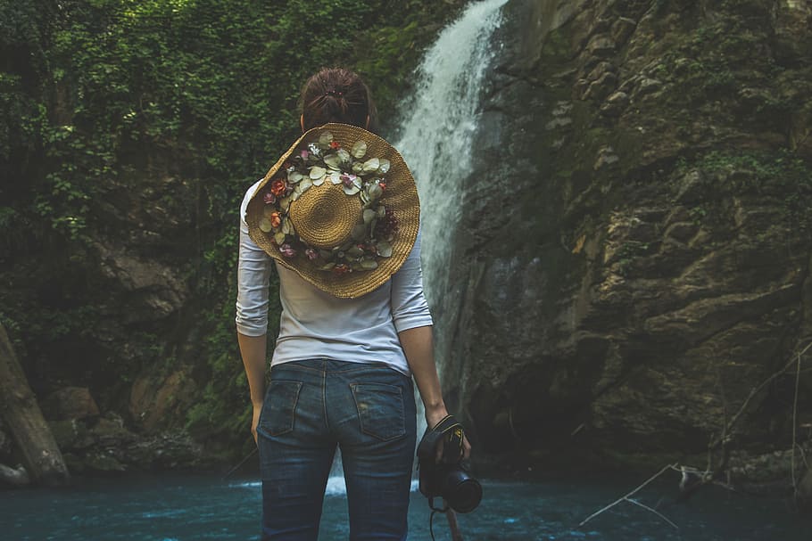 woman standing in front of waterfalls, hat, camera, hiking, person HD wallpaper