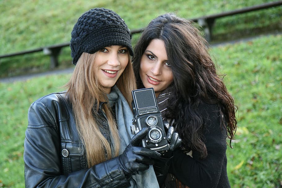 photography of two women holding camera, old camera, girlfriends HD wallpaper