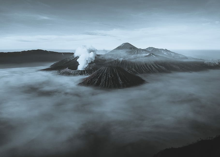 volcano covering with fog, aerial shot of mountains, java, indonesia