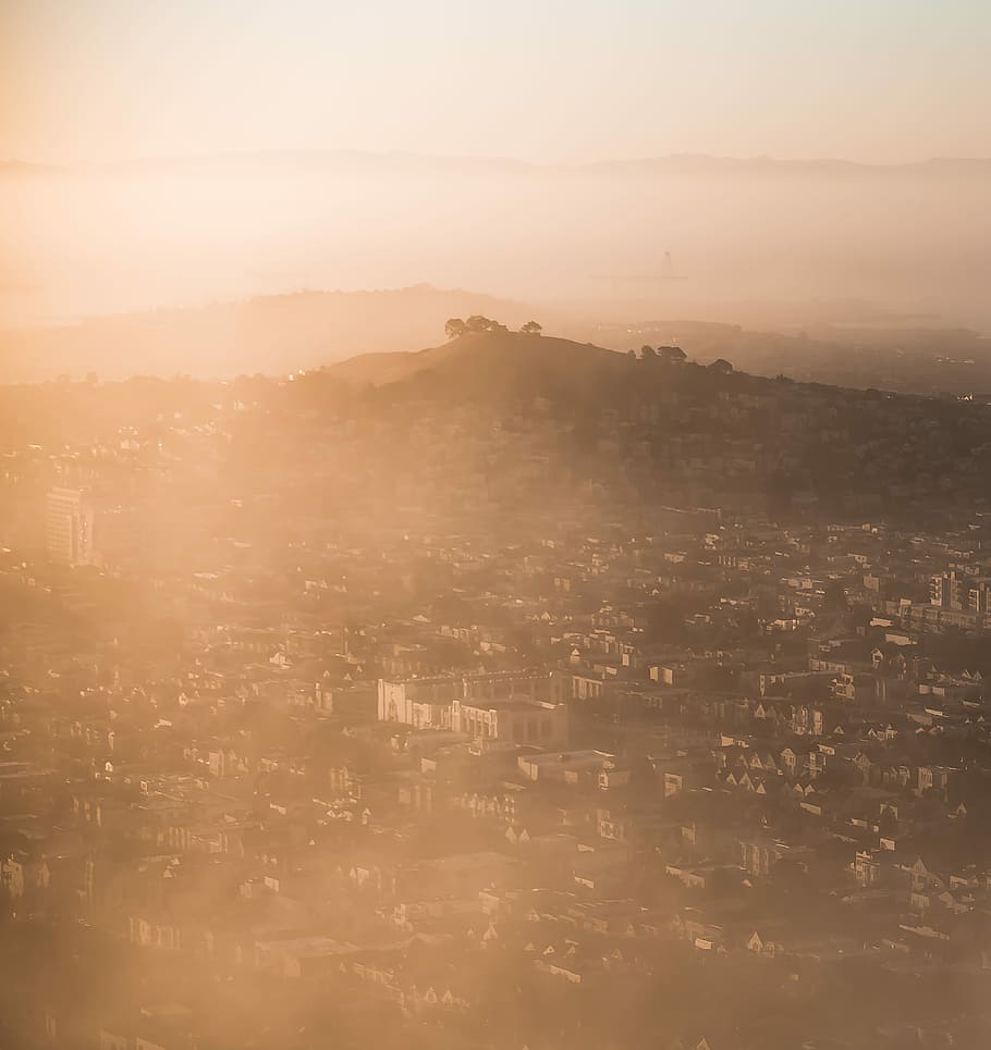 aerial photo of city during sunrise, aerial view of houses and mountains under gray sky HD wallpaper