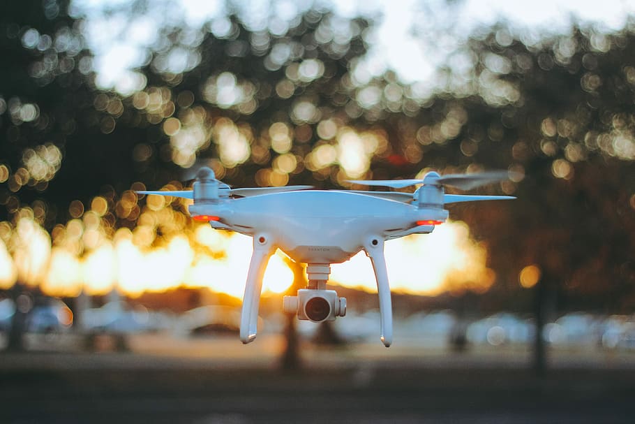 white quadcopter drone, white and black video streaming drone with bokeh lights HD wallpaper