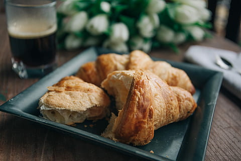 croissant on green ceramic plate beside drinking glass with coffee HD wallpaper