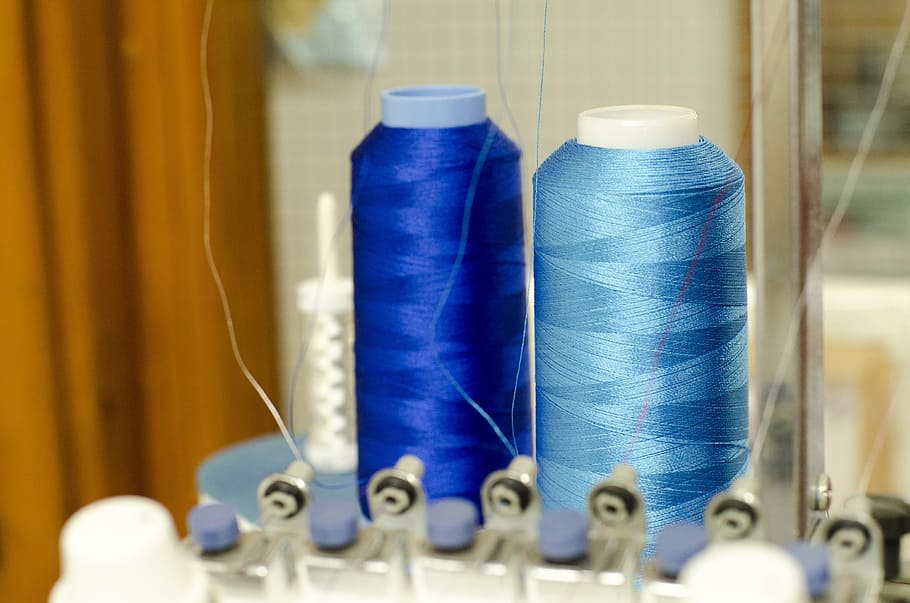 two blue and teal threads on interlocking machine, embroidery HD wallpaper