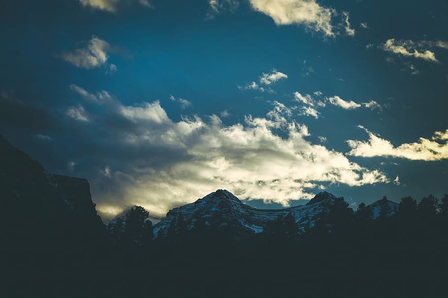 silhouette photography of mountain peak under alto cumulus clouds HD wallpaper