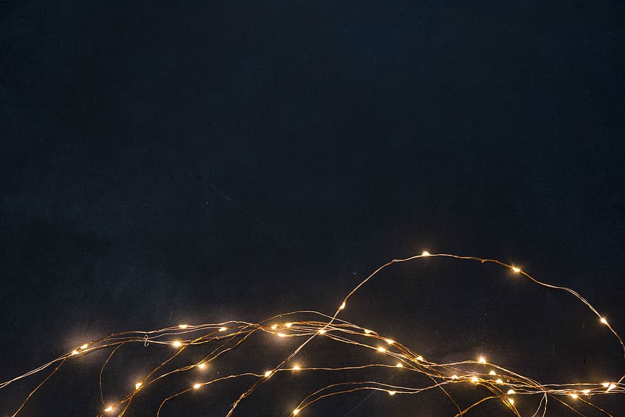 string lights turned on, brown string lights under black sky during night time HD wallpaper