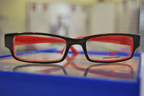 eyeglasses with black frames on shallow focus lens, optics HD wallpaper