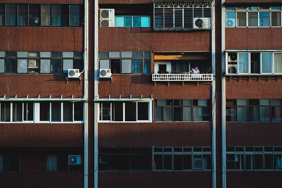 person at the balcony of a building during day, person watering can on window rail HD wallpaper
