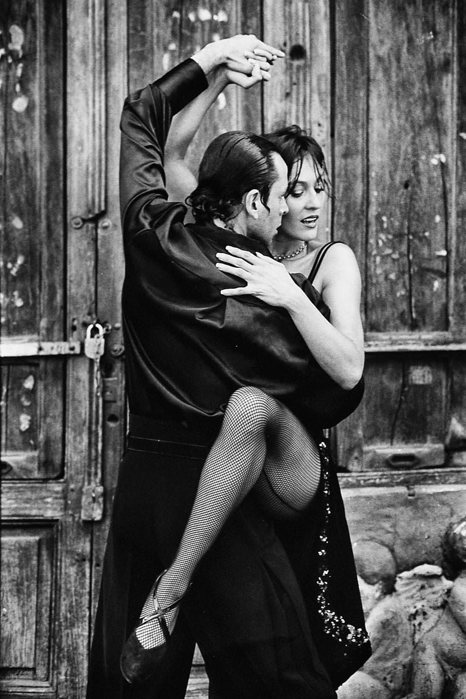 grayscale photo of man holding woman in dress, tango, dancing