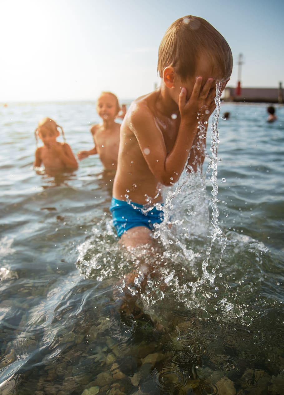 boy wearing blue swimming trunks wiping his wet face, sea, ocean HD wallpaper