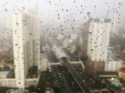high angle photography of water drew and overlooking building, shallow focus photography of water droplets on glass panel HD wallpaper