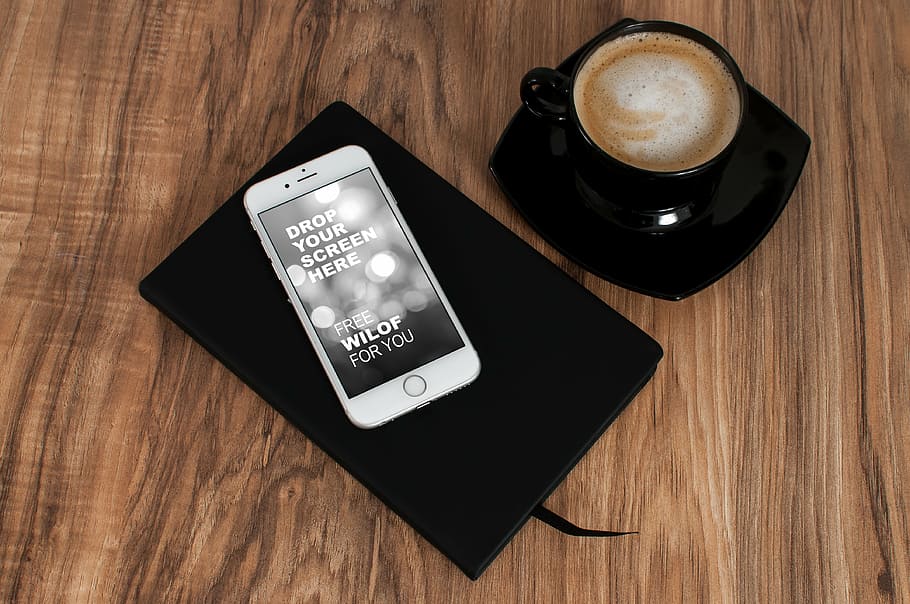 silver iPhone 6 on top of black notebook near black ceramic coffee mug with saucer HD wallpaper