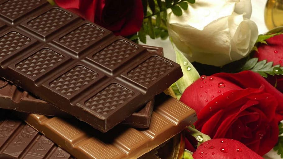 chocolate bars on top of red and white roses, candy, dark, sweet