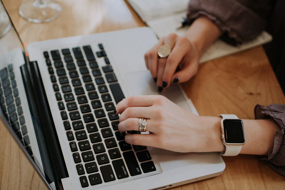person using MacBook, person in silver ring holds a MacBook Pro HD wallpaper
