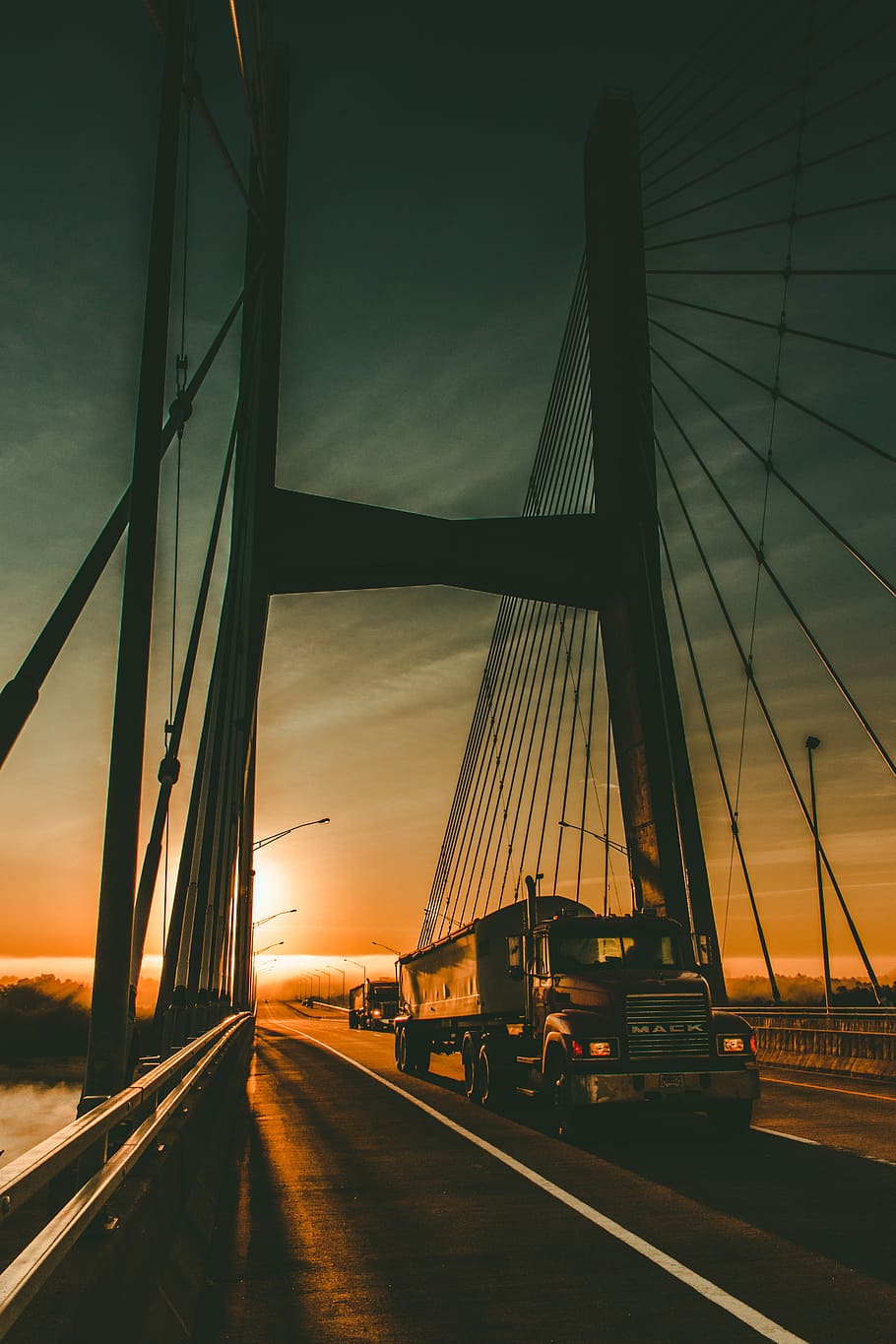 brown Maek freight truck on bridge during dawn, red MACK trailer truck running steel bridge during golden hour HD wallpaper
