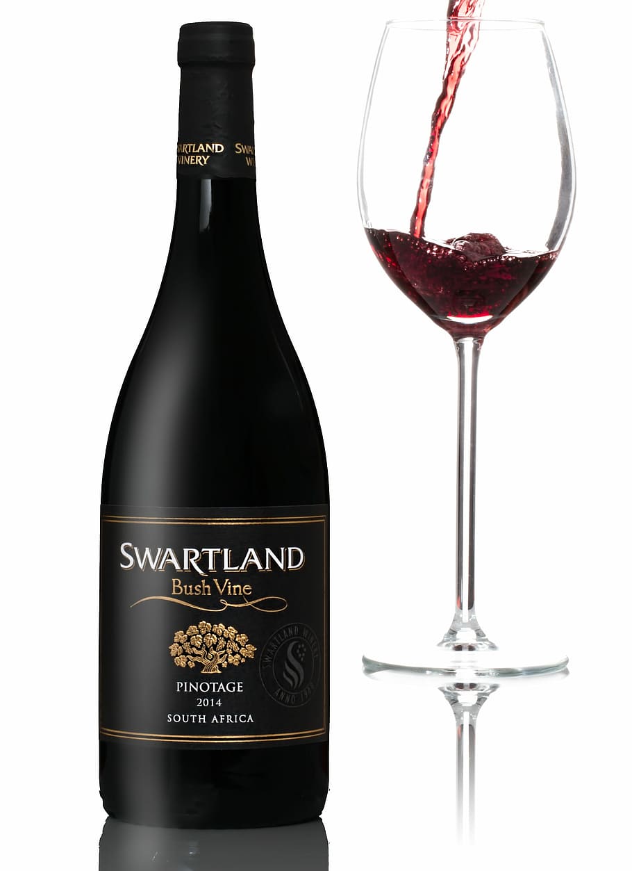 Swartland Bush Vine wine bottle beside clear wine glass, red wine