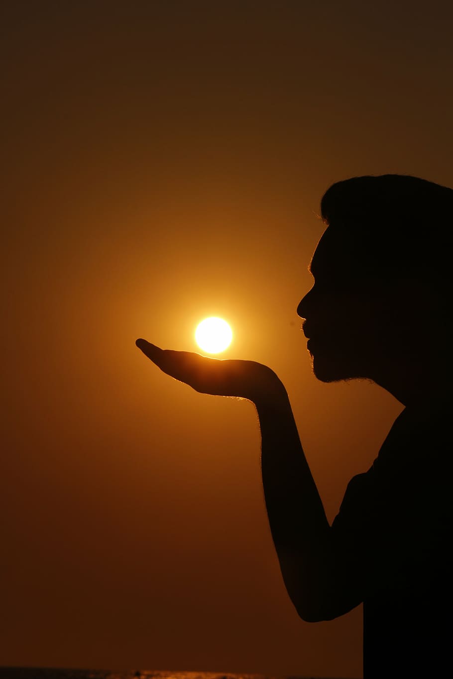 silhouette of a person as if he/she is summoning the sun on his/her hand, HD wallpaper