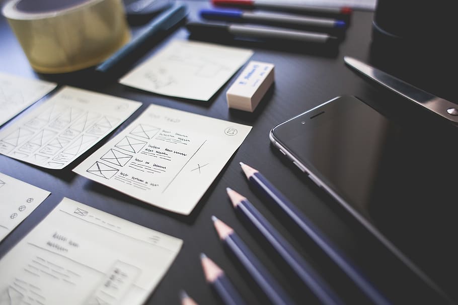 space gray iPhone 6 on table beside a black pens, work, create HD wallpaper