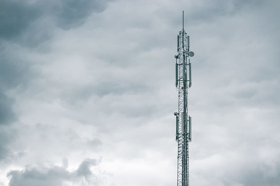 gray radio tower under the cloudy sky during daytime, photo of telecommuncation tower