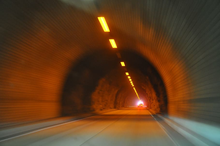 panning photography of vehicle travelling in tunnel with light HD wallpaper
