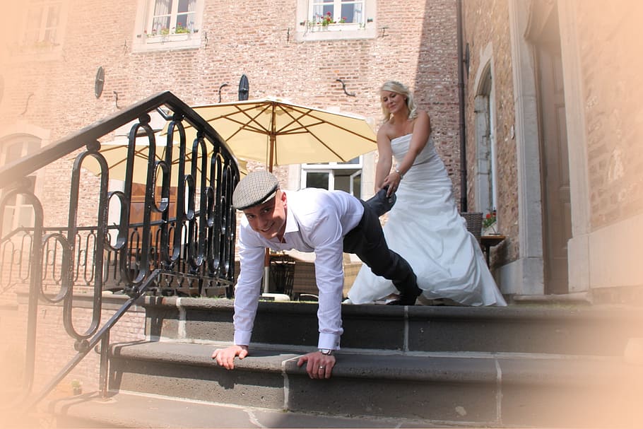 woman holding mans foot outdoors, bride, groom, game, wedding HD wallpaper