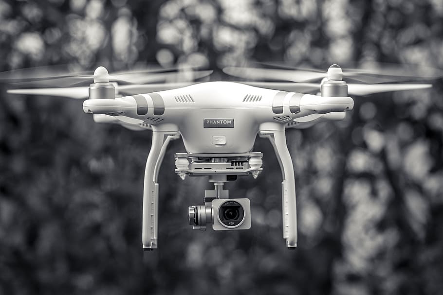 photo of DJI Phantom drone, black and white, flying, focus on foreground HD wallpaper