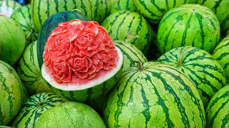 closeup photography of watermelon fruits, melons, display, carved