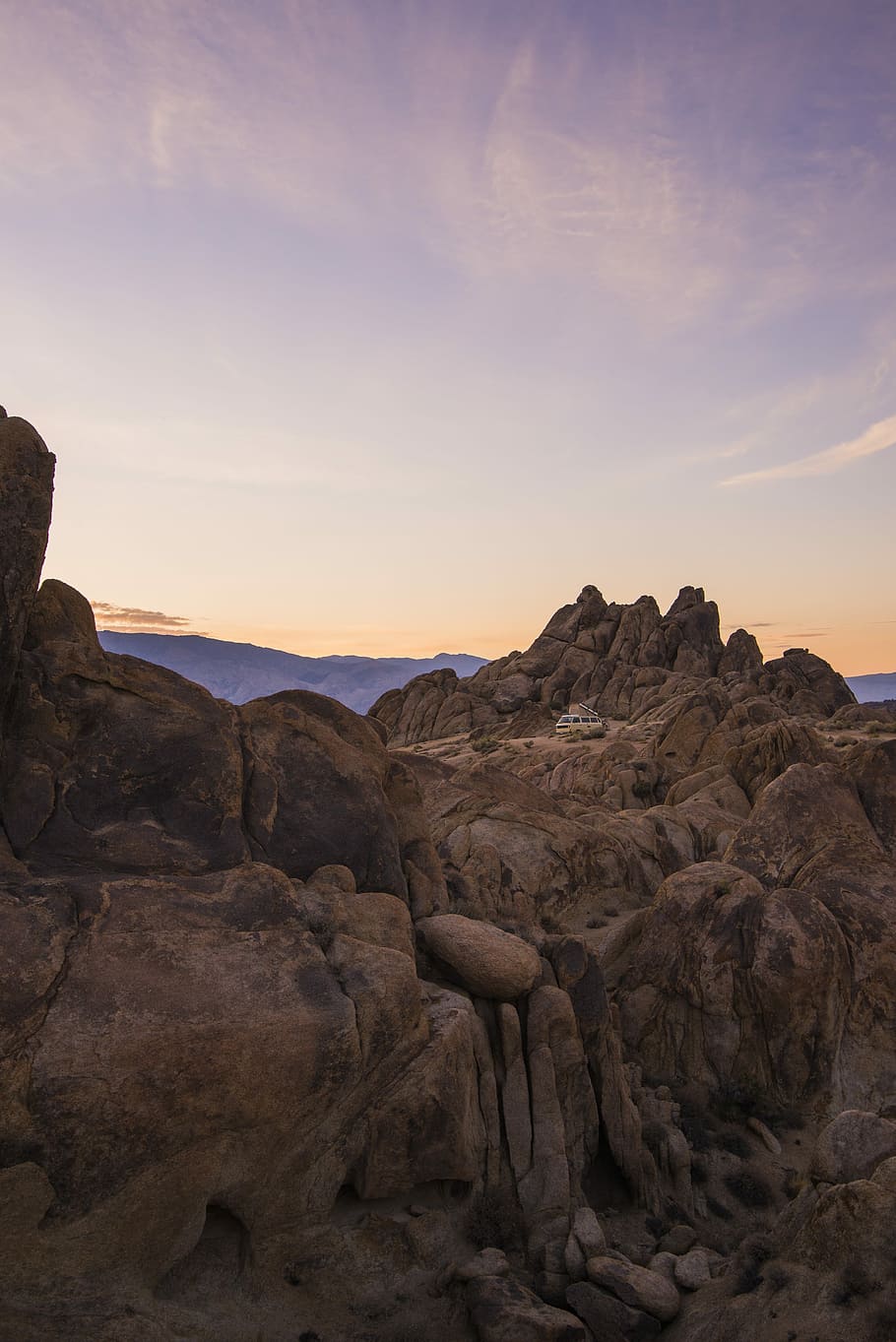 high angle photo of moutain, vehicle travelling on rock formation during golden hour HD wallpaper