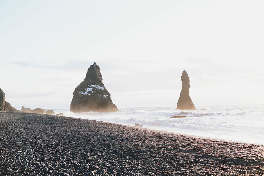two black rock formations near shore at daytime, rock formation by the ocean during daytime HD wallpaper