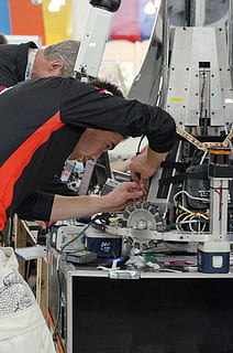 person repairing machine, engineer, robotics, informatics, student HD wallpaper