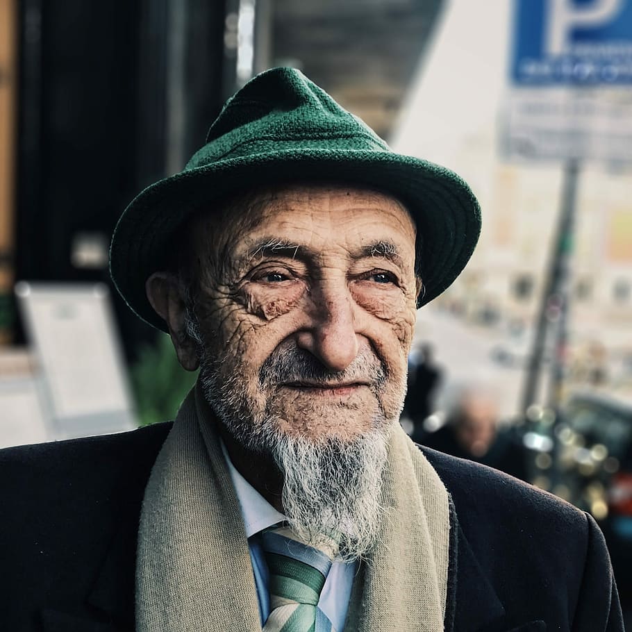man wearing green hat during daytime, shallow focus photography of man HD wallpaper