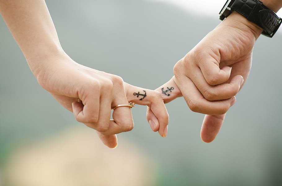 two person showing anchor finger tattoos, hands, love, couple
