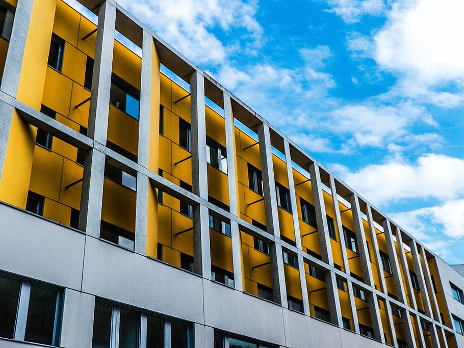 gray and tellow concrete building, low angle photography of gray building at daytime HD wallpaper