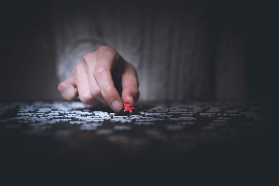 person holding red jigsaw puzzle, person holding a red jigsaw puzzle piece HD wallpaper