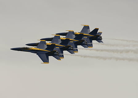 four blue-and-yellow fighter planes flying in the sky during daytime HD wallpaper