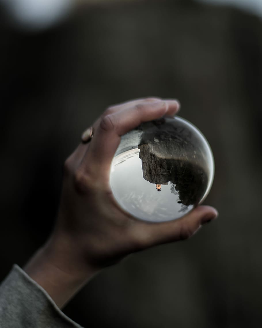 person holding clear glass water globe, person holding clear glass ball HD wallpaper