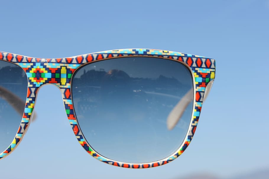 red, blue, and yellow framed Wayfarer-style sunglasses, shades