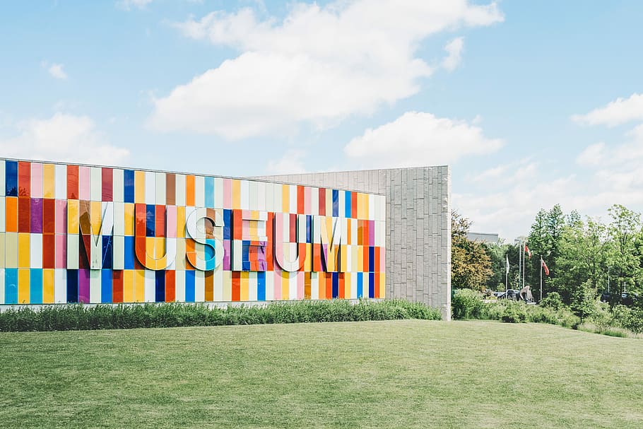 multi-colored Museum outdoor wall surrounded by green grass under blue cloudy sky HD wallpaper