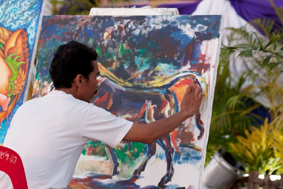 man painting while sitting during daytime, artist, finger painting