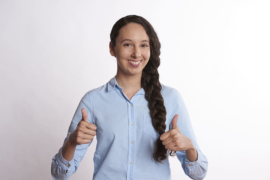 woman with braided hair wearing teal button-up dress shirt giving two thumbs up sign, HD wallpaper