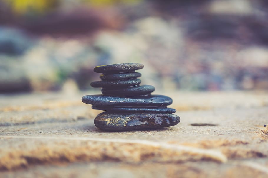 black stone arrangement in closeup photography, black stones on brown surface HD wallpaper