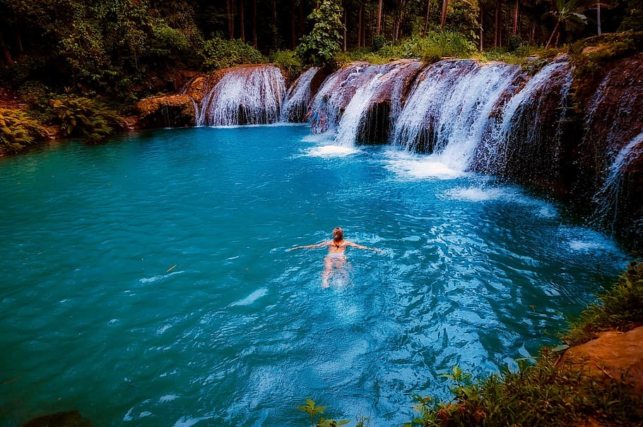 woman swimming on body of water during daytime, waterfall, falls HD wallpaper