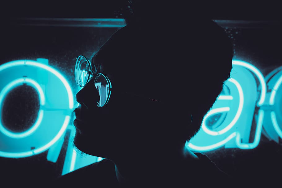 man wearing sunglasses beside LED sign, man wearing eyeglasses HD wallpaper