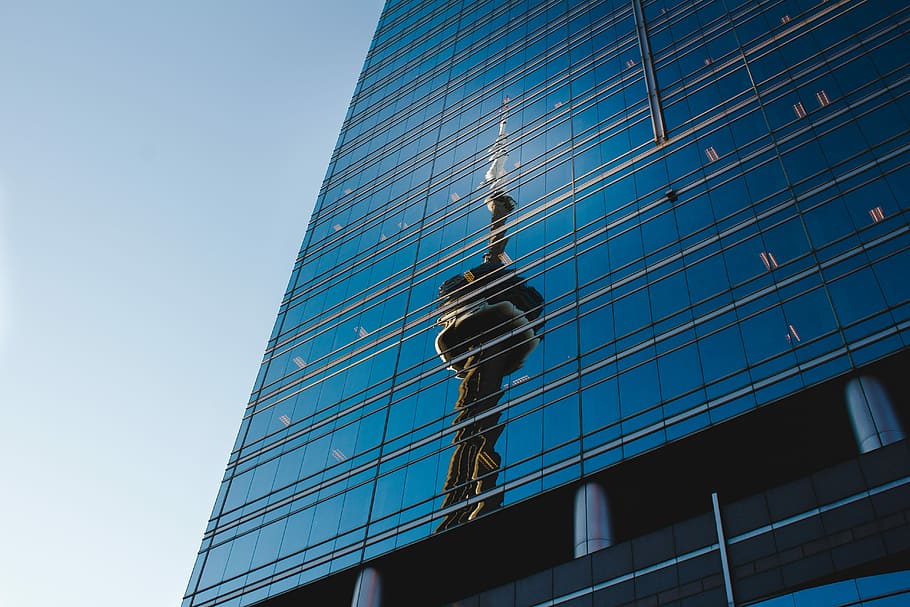 structure in worm's eye view, reflection of CN Tower on building's glass windows HD wallpaper