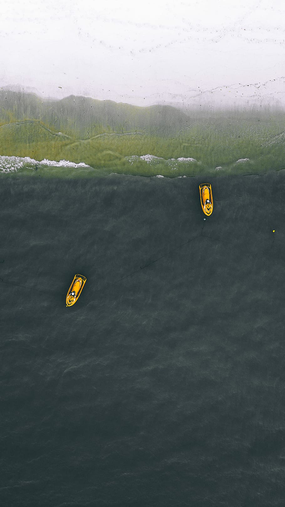two yellow personal watercraft on water, aerial view photography of two boats on body of water near seashore during daytime HD wallpaper