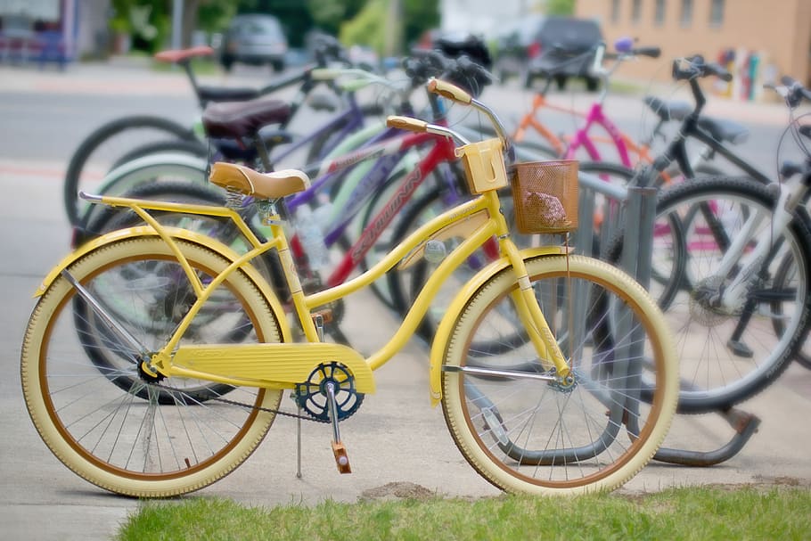 yellow cruiser bike parked beside bicycles, vintage bikes, retro