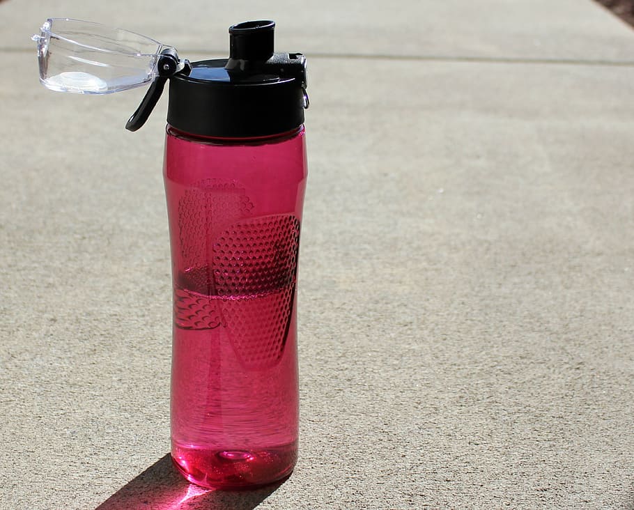 red and black opened sports bottle with liquid inside, water bottle